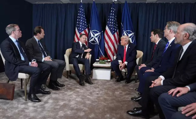 President Donald Trump, center right, meets with NATO Secretary General Mark Rutte, center left, during a meeting on the sidelines of the Annual Meeting of the World Economic Forum in Davos, Switzerland, Wednesday, Jan. 21, 2026. (AP Photo/Evan Vucci)