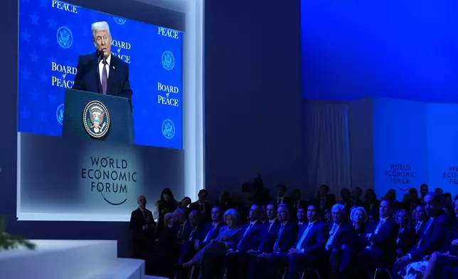 President Donald Trump is shown on a large screen as he speaks during a Board of Peace charter announcement during the Annual Meeting of the World Economic Forum in Davos, Switzerland, Thursday, Jan. 22, 2026. (AP Photo/Evan Vucci)