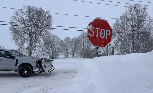 A driver navigates fresh snowfall in Lowville, New York, on Friday, Jan. 23, 2026. (AP Photo/Cara Anna)
