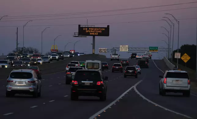 A sign visible from the eastbound lanes of Highway 121 warns of road preparations ahead of inclement weather expected in the region Wednesday, Jan. 21, 2026, in Fort Worth, Texas. (AP Photo/Julio Cortez)