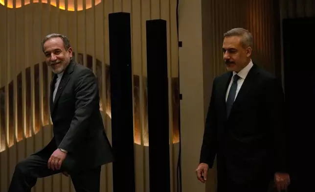 Iranian Foreign Minister Abbas Araghchi, left, smiles as he arrives with his Turkish counterpart Hakan Fidan to a joint press conference in Istanbul, Turkey, Friday, Jan. 30, 2026. (AP Photo/Khalil Hamra)