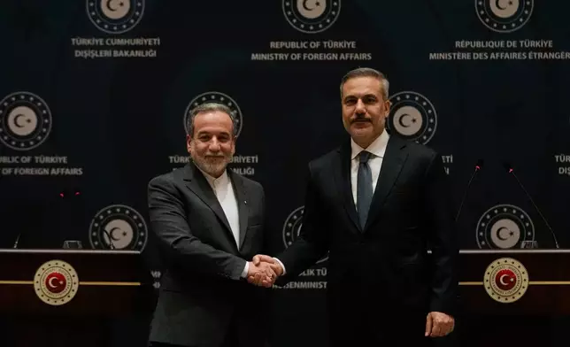 Turkish Foreign Minister Hakan Fidan, right, shakes hands with his Iranian counterpart Abbas Araghchi following a joint press conference in Istanbul, Turkey, Friday, Jan. 30, 2026. (AP Photo/Khalil Hamra)