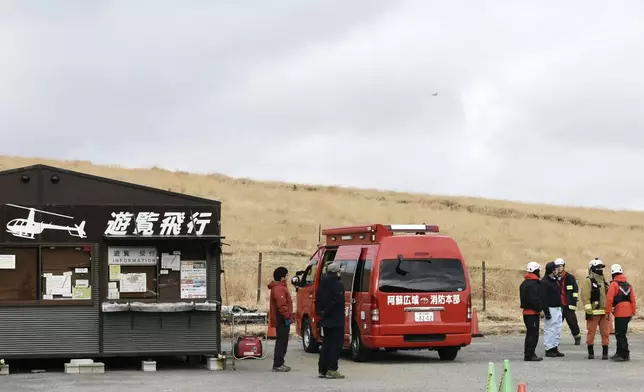 Firefighters gather at a search base for a missing sightseeing helicopter near Mount Aso in Kumamoto Prefecture, southwestern Japan, Tuesday, Jan. 20, 2026. (Kodai Mitsui/Kyodo News via AP)