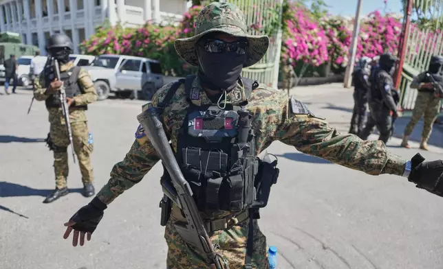 Members of the National Palace General Security Unit (USGPN) set up a security perimeter as Transitional Council President Laurent Saint-Cyr visits the headquarters of the armed forces in Port-au-Prince, Haiti, Monday, Jan. 26, 2026. (AP Photo/Odelyn Joseph)