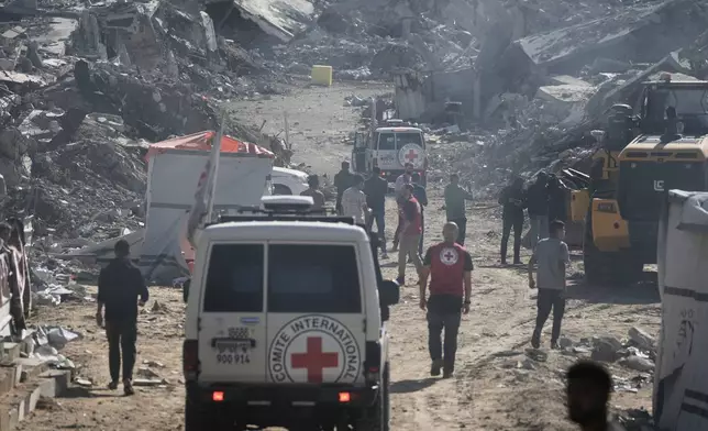 A yellow block demarcating the "Yellow Line," which has separated the Gaza Strip's Israeli-held and Palestinian zones since the October ceasefire, is visible in Jabalia, northern Gaza Strip during searching for the remains of hostages, Monday, Dec. 1, 2025. (AP Photo/Jehad Alshrafi)