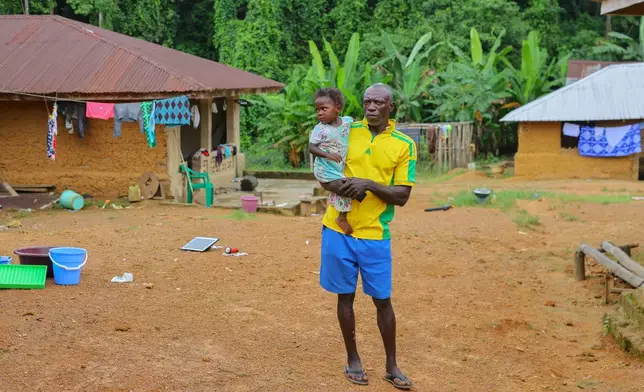 Boima G. Kamara, who has lived his entire life in Jikando, is preparing to relocate because mining pollution has poisoned the river his village depends on, July 8, 2025, in Jikando, Liberia. (AP Photo/Misper Apawu)