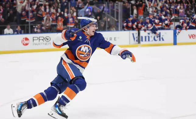 New York Islanders' Matthew Schaefer celebrates after his goal in the overtime period of an NHL hockey game against the Toronto Maple Leafs, Saturday, Jan. 3, 2026, in Elmont, N.Y. (AP Photo/Heather Khalifa)