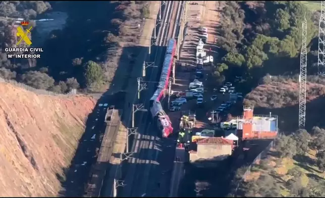 In this aerial view grab taken from video provided by Guardia Civil, a view of the Iryo train with rescue workers at the scene after a high-speed train collision, near Adamuz, Spain, Monday, Jan. 19, 2026. (Guardia Civil via AP)