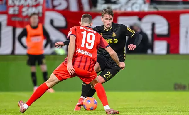 Heidenheim's Jonas Föhrenbach and Köln's Sebastian Sebulonsen, right, in action during the Bundesliga soccer match between FC Heidenheim and FC Köln in Heidenheim, Germany, Saturday Jan. 10, 2026. (Harry Langer/dpa via AP)