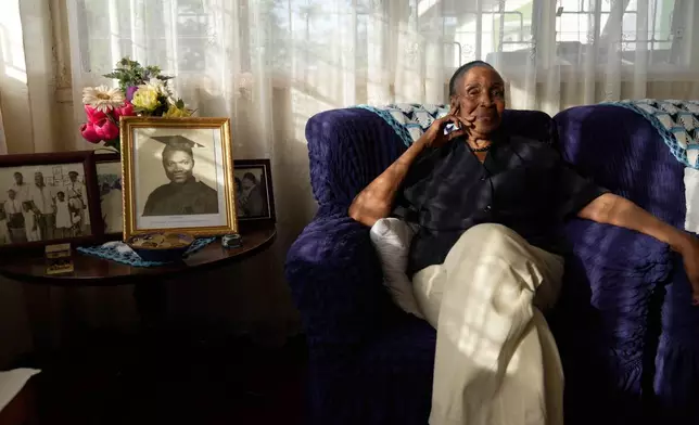 Widow Marie Owino, 87 years old, a former teacher sits inside her home in Siaya, Kenya, Thursday, Nov. 27, 2025. (AP Photo/Brian Inganga)