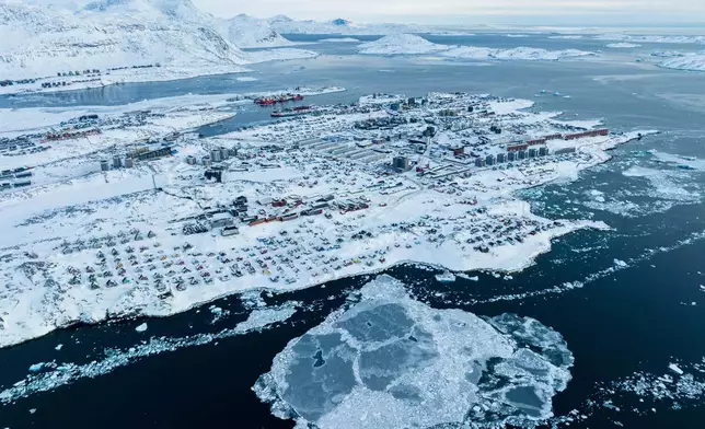 FILE - Houses covered by snow are seen on the coast of a sea inlet of Nuuk, Greenland, on March 7, 2025. (AP Photo/Evgeniy Maloletka, File)
