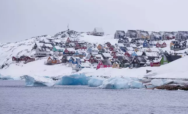 FILE - Coloured houses covered by snow are seen from the sea in Nuuk, Greenland, on March 6, 2025. (AP Photo/Evgeniy Maloletka, File)