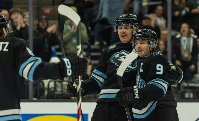 Utah Mammoth center Clayton Keller (9) and left wing Lawson Crouse (67) celebrate the goal against the Ottawa Senators during the first period of an NHL hockey game Wednesday, Jan. 7, 2026, in Salt Lake City. (AP Photo/Melissa Majchrzak)