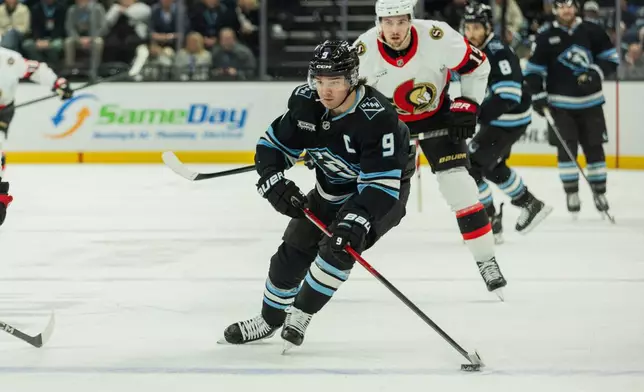 Utah Mammoth center Clayton Keller (9) skates with the puck against the Ottawa Senators during the first period of an NHL hockey game Wednesday, Jan. 7, 2026, in Salt Lake City. (AP Photo/Melissa Majchrzak)