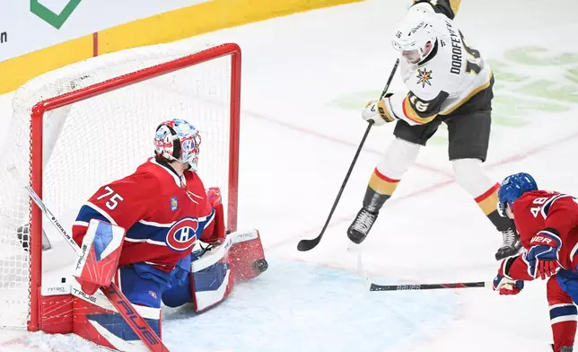Montreal Canadiens goaltender Jakub Dobes (75) stops Vegas Golden Knights' Pavel Dorofeyev (16) as Canadiens' Lane Hutson (48) defends during the second period of an NHL hockey game in Montreal, Tuesday, Jan. 27, 2026. (Graham Hughes/The Canadian Press via AP)
