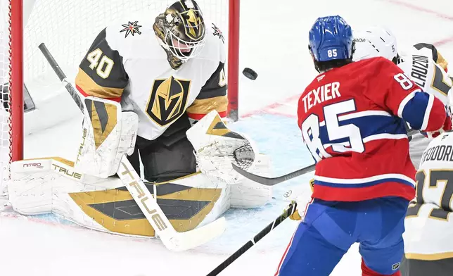 Montreal Canadiens' Alexandre Texier (85) takes a shot on Vegas Golden Knights goaltender Akira Schmid (40) during the first period of an NHL hockey game in Montreal, Tuesday, Jan. 27, 2026. (Graham Hughes/The Canadian Press via AP)