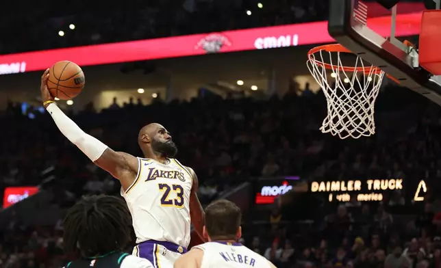 Los Angeles Lakers forward LeBron James (23) dunks against the Portland Trail Blazers during the first half of an NBA basketball game Saturday, Jan. 17, 2026, in Portland, Ore. (AP Photo/Amanda Loman)