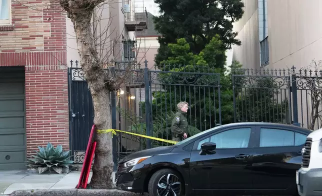 An animal control officer stands in front where a mountain lion has been trapped between buildings in neighborhood in San Francisco, Tuesday, Jan. 27, 2026. (AP Photo/Andy Bao)