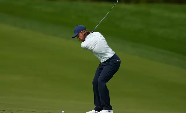 Tommy Fleetwood of England plays his second shot on the 3rd hole during second round of the Dubai Desert Classic in United Arab Emirates, Friday, Jan. 23, 2026. (AP Photo/Altaf Qadri)
