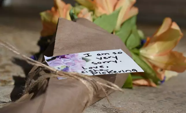 A note attached to a bundle of flowers left outside the Beth Israel Congregation reads, I am so very sorry," on Monday, Jan. 12, 2026, in Jackson, Miss. (AP Photo/Sophie Bates)
