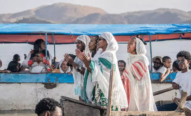 Ethiopian orthodox believers ride a boat to celebrate Timket, the Ethiopian Epiphany, on lake Dembel, in Batu, Ethiopia, Sunday, Jan. 18, 2026. (AP Photo/Amanuel Sileshi)