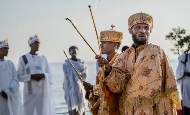 Orthodox worshipers celebrate Timket, the Ethiopian Epiphany, on lake Dembel, in Batu, Ethiopia, Monday, Jan. 19, 2026. (AP Photo/Amanuel Sileshi)