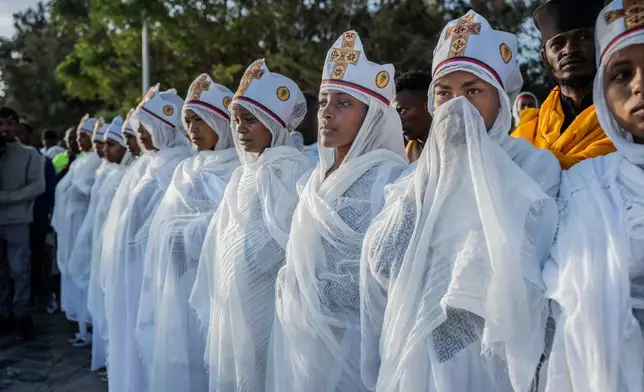 Ethiopian Orthodox devotees attend a prayer during the celebration of the Ethiopian Epiphany on the shore of lake Dembel, in Batu, Ethiopia, Monday, Jan. 19, 2026. (AP Photo/Amanuel Sileshi)