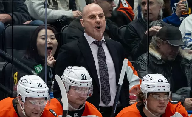 Philadelphia Flyers head coach Rick Tocchet yells during the third period of an NHL game against the Vancouver Canucks in Vancouver, on Tuesday, Dec. 30, 2025. (Ethan Cairns/The Canadian Press via AP)