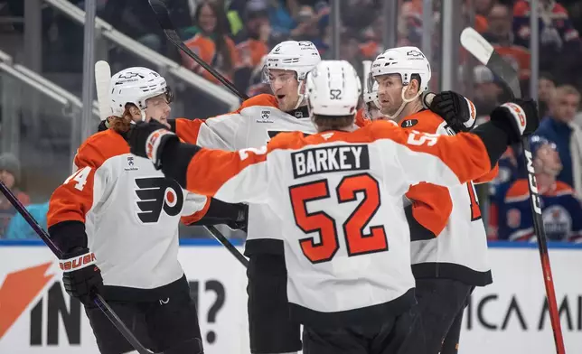 Philadelphia Flyers' Owen Tippett (74), Travis Sanheim (6), Denver Barkey (52) and Travis Konecny (11) celebrate a goal against the Edmonton Oilers during the first period of an NHL hockey game, in Edmonton, Saturday, Jan. 3, 2026. (Jason Franson/The Canadian Press via AP)