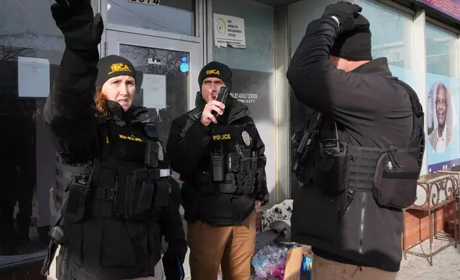 BCA officers stand near the scene of a fatal shooting that took place yesterday, in Minneapolis, Sunday, Jan. 25, 2026. (AP Photo/Adam Gray)