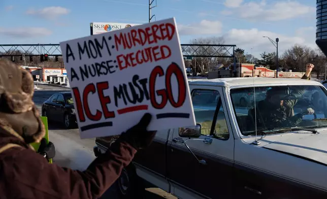 People protest against ICE (Immigration and Customs Enforcement) in Omaha, Neb. on Sunday, Jan. 25, 2026. (Nikos Frazier/Omaha World-Herald via AP)