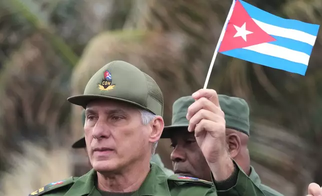 Cuban President Miguel Diaz-Canel marches during a rally to protest the killing of Cuban officers during the U.S. operation in Venezuela that captured Venezuelan President Nicolas Maduro outside the U.S. Embassy in Havana, Cuba, Friday, Jan. 16, 2026. (AP Photo/Ramon Espinosa)