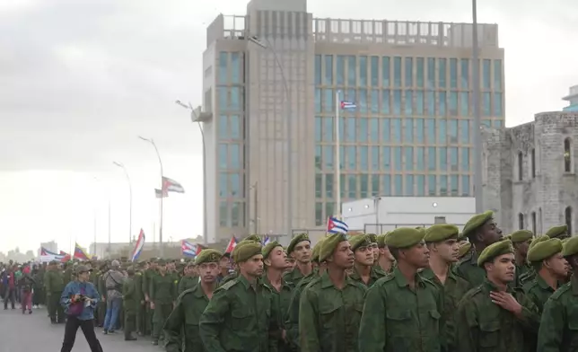 Soldiers march outside the U.S. Embassy during a rally to protest the killing of Cuban officers during the U.S. operation in Venezuela that captured Venezuelan President Nicolas Maduro in Havana, Cuba, Friday, Jan. 16, 2026. (AP Photo/Ramon Espinosa)