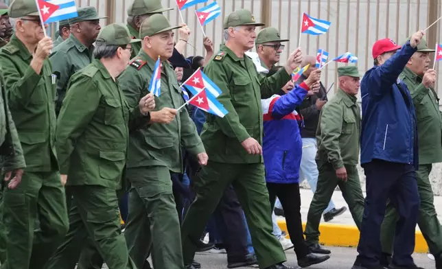Cuban President Miguel Diaz-Canel marches during a rally to protest the killing of Cuban officers during the U.S. operation in Venezuela that captured Venezuelan President Nicolas Maduro in Havana, Cuba, Friday, Jan. 16, 2026. (AP Photo/Ramon Espinosa)