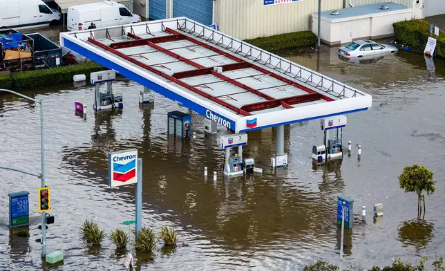 Streets are flooded by the "King Tides", occurring when the sun, moon and Earth align, causing a stronger gravitational pull Saturday, Jan. 3, 2026, near Corte Madera in Marin County, Calif. (AP Photo/Ethan Swope)