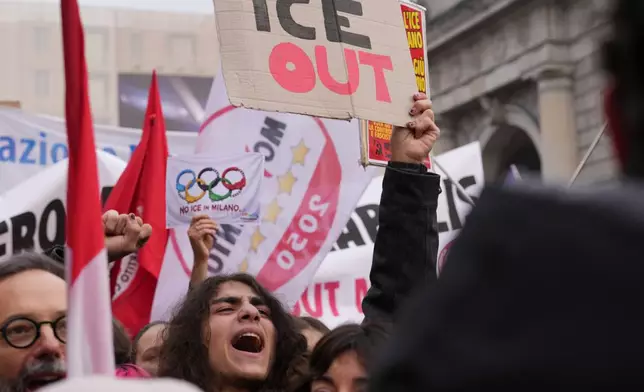 A person holds a sign, during an Anti-ICE demonstration, ahead of the 2026 Winter Olympics, in Milan, Italy, Saturday, Jan. 31, 2026. (AP Photo/Antonio Calanni)