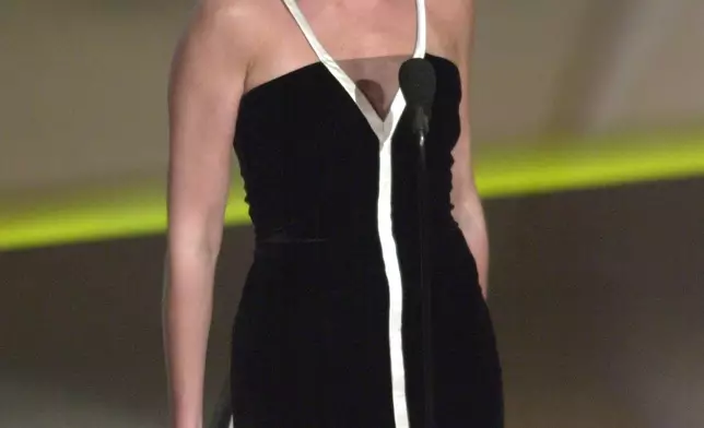 FILE - Julia Roberts, wearing a gown designed by Valentino Garavani, reacts after winning the Oscar for best actress in a leading role for the film "Erin Brockovich," during the 73rd annual Academy Awards March 25, 2001, in Los Angeles. (AP Photo/Kevork Djansezian, File)