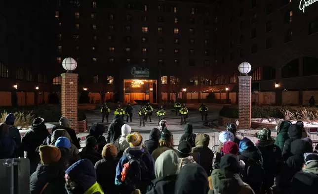People participate during a noise demonstration outside the Graduate by Hilton Minneapolis hotel on Wednesday, Jan. 28, 2026, in Minneapolis. (AP Photo/Adam Gray)
