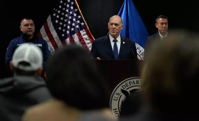 White House border czar Tom Homan holds a news conference as Marcos Charles and Rodney Scott, listen, at the Bishop Whipple Federal building on Thursday, Jan. 29, 2026 in Minneapolis. (AP Photo/Julia Demaree Nikhinson)