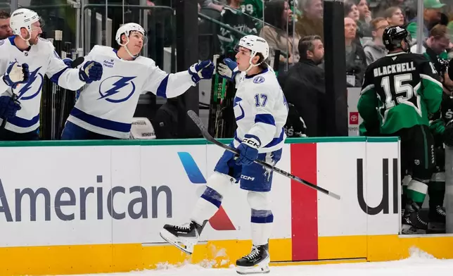 Tampa Bay Lightning center Dominic James (17) celebrates with the bench after scoring in the first period of an NHL hockey game against the Dallas Stars in Dallas, Sunday, Jan. 18, 2026. (AP Photo/Tony Gutierrez)