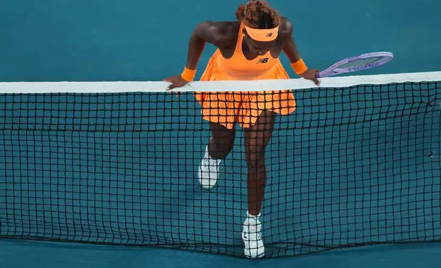 Coco Gauff of the U.S. runs into the net during her quarterfinal against Elina Svitolina of Ukraine at the Australian Open tennis championship in Melbourne, Australia, Tuesday, Jan. 27, 2026. (AP Photo/Dita Alangkara)