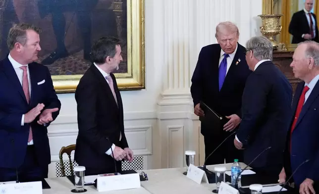 President Donald Trump talks with Valero Chief Executive Officer and President Lane Riggs, second from right, while Tallgrass Energy President and Chief Executive Officer Matt Sheehy, far left, Repsol Chief Executive Officer Josu Jon Imaz, second from left, and Chairman and Chief Executive Officer of Continental Resources Harold Hamm, far right, look on during a meeting in the East Room of the White House, Friday, Jan. 9, 2026, in Washington. (AP Photo/Alex Brandon)