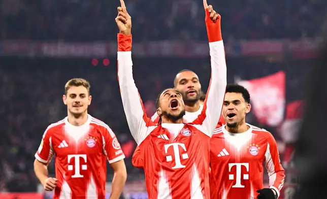 Munich's Michael Olise celebrates scoring during the Bundesliga soccer match between Bayern Munich and VfL Wolfsburg in Munich, Germany, Sunday Jan. 11, 2026. (Tom Weller/dpa via AP)