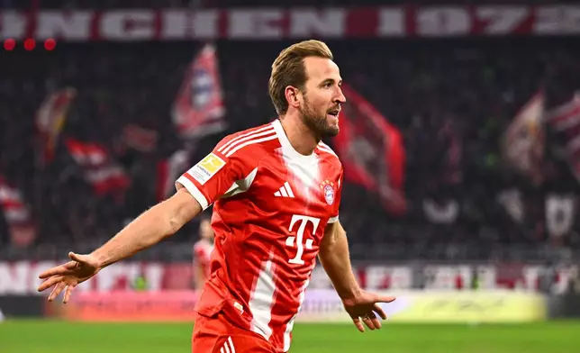 Munich's Harry Kane celebrates scoring during the Bundesliga soccer match between Bayern Munich and VfL Wolfsburg in Munich, Germany, Sunday Jan. 11, 2026. (Tom Weller/dpa via AP)