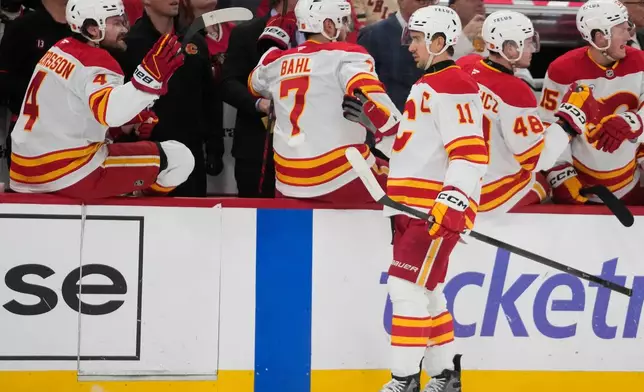 Calgary Flames center Mikael Backlund (11) celebrates his goal on the Chicago Blackhawks during the first period of an NHL hockey game Thursday, Jan. 15, 2026, in Chicago. (AP Photo/Erin Hooley)