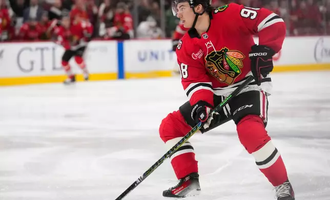 Chicago Blackhawks center Connor Bedard handles the puck during the third period of an NHL hockey game against the Calgary Flames, Thursday, Jan. 15, 2026, in Chicago. (AP Photo/Erin Hooley)