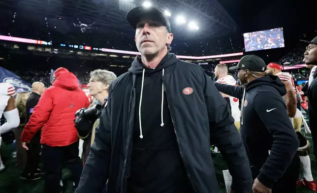 San Francisco 49ers head coach Kyle Shanahan walks on the field after an NFL football divisional playoff game against the Seattle Seahawks, Saturday, Jan. 17, 2026, in Seattle. (AP Photo/John Froschauer)