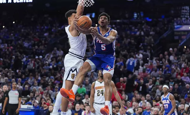 Denver Nuggets' Hunter Tyson (5) goes up to shoot against Denver Nuggets' Spencer Jones during the first half of an NBA basketball game Monday, Jan. 5, 2026, in Philadelphia. (AP Photo/Matt Rourke)