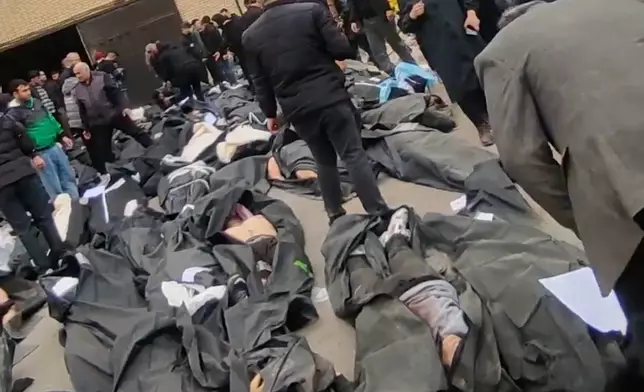 This frame grab from videos taken between Jan. 9 and Jan. 11, 2026, and circulating on social media purportedly shows images from a morgue with dozens of bodies and mourners after crackdown on the outskirts of Iran's capital, in Kahrizak, Tehran Province. (UGC via AP)