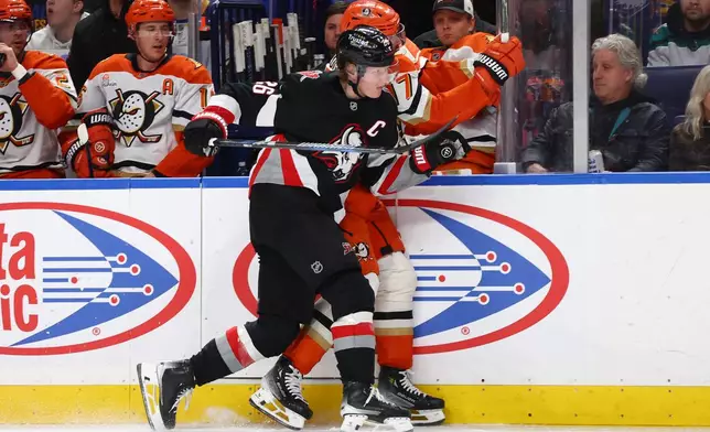 Buffalo Sabres defenseman Rasmus Dahlin (26) checks Anaheim Ducks left wing Alex Killorn (17) into the boards during the second period of an NHL hockey game Saturday, Jan. 10, 2026, in Buffalo, N.Y. (AP Photo/Jeffrey T. Barnes)